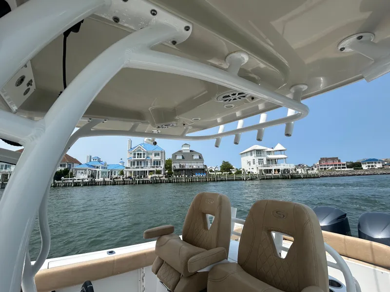 Slide: The Image of 2018 Sportsman Open 312 Center Console boat with waterfront homes in the background. - 14