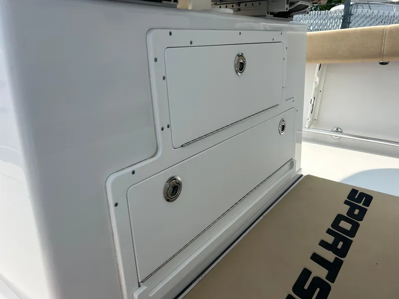 Slide: The Image of 2018 Sportsman Open 312 Center Console storage compartments on a boat deck. - 17