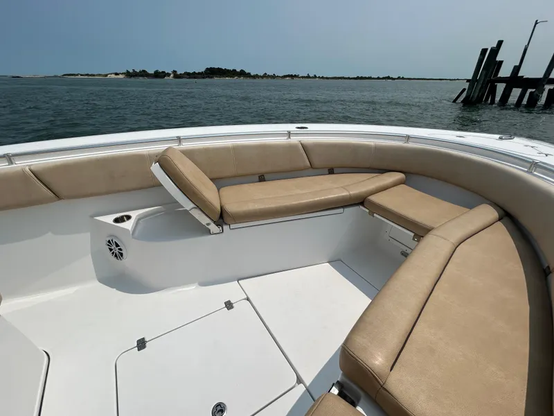 Slide: The Image of 2018 Sportsman Open 312 Center Console boat with tan seating, on calm water. - 22