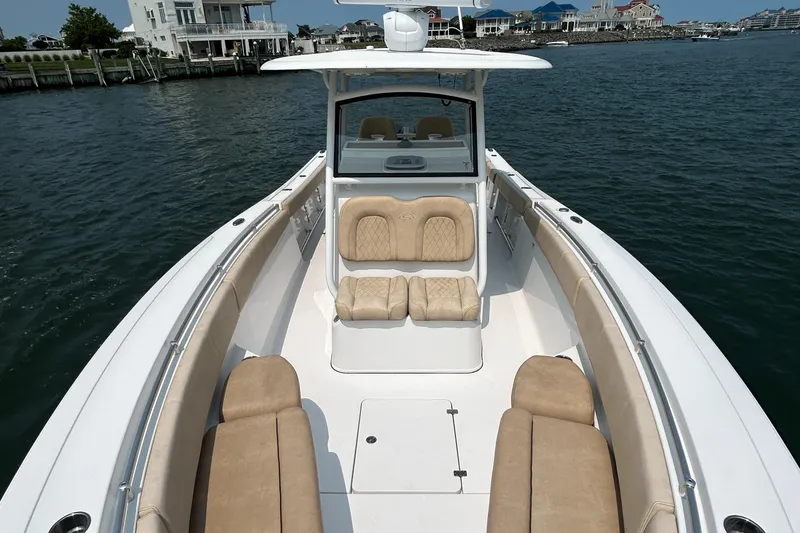 Slide: The Image of 2018 Sportsman Open 312 Center Console boat on water, featuring spacious seating and sleek design. - 25