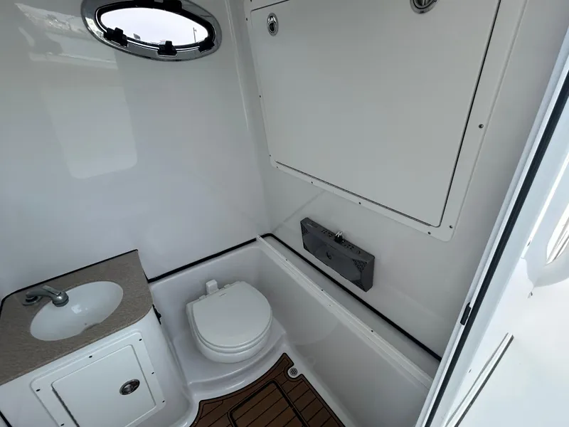 Slide: The Image of 2018 Sportsman Open 312 Center Console boat bathroom with sink and toilet. - 27