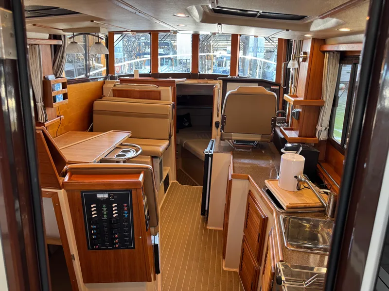 Slide: The Image of Interior of 2020 Ranger Tugs R-31 S, featuring wood finishes and modern amenities. - 10