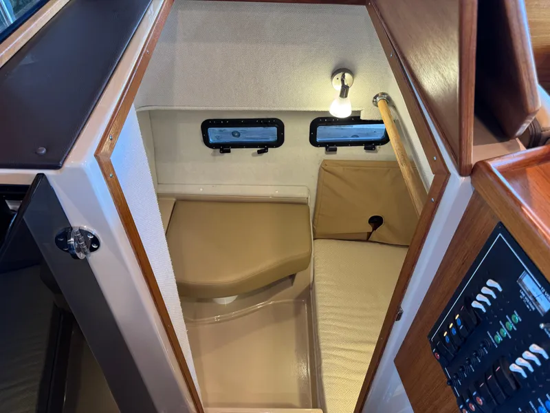 Slide: The Image of 2020 Ranger Tugs R-31 S cabin interior with seating and control panel. - 13