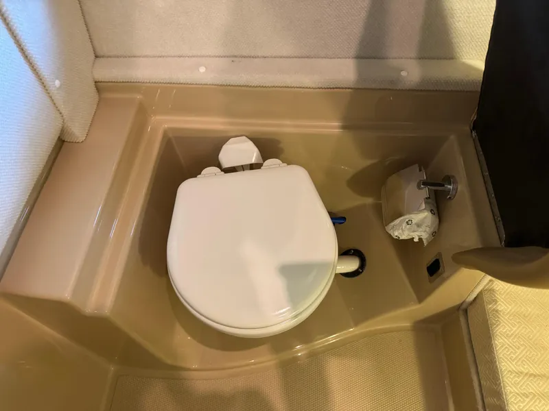 Slide: The Image of 2020 Ranger Tugs R-31 S boat bathroom with compact toilet and beige flooring. - 14