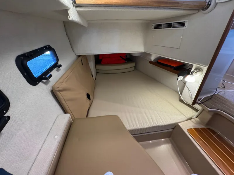 Slide: The Image of 2020 Ranger Tugs R-31 S cabin interior with cozy sleeping area and porthole window. - 15