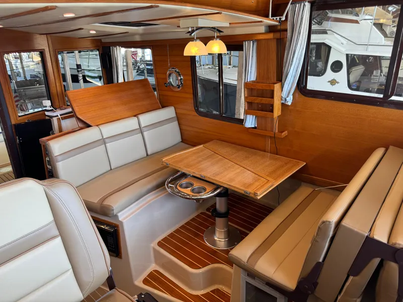 Slide: The Image of Interior of 2020 Ranger Tugs R-31 S, featuring elegant wood finishes and comfortable seating. - 20