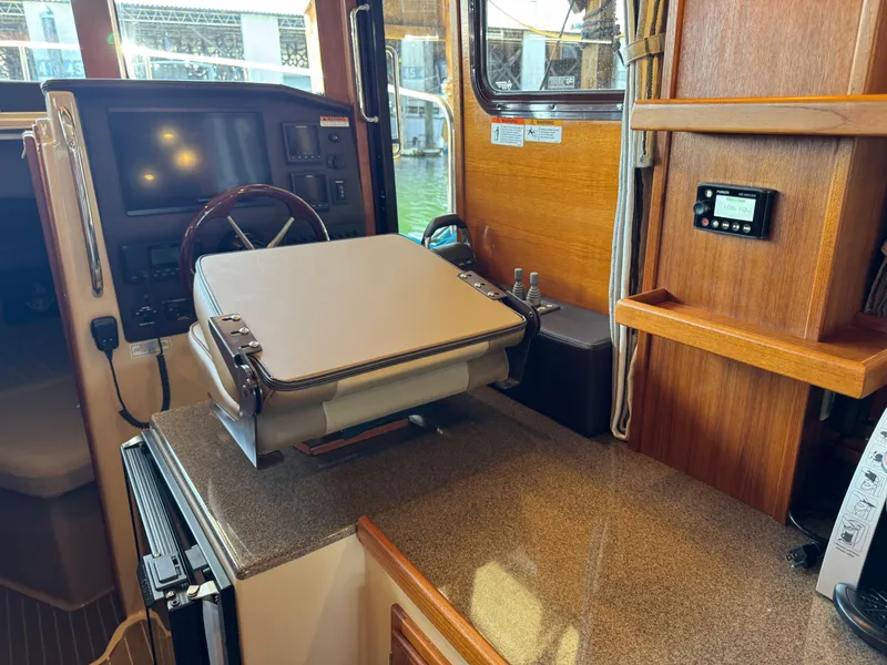 Slide: The Image of Interior of 2020 Ranger Tugs R-31 S boat with helm station and wooden cabinetry. - 22