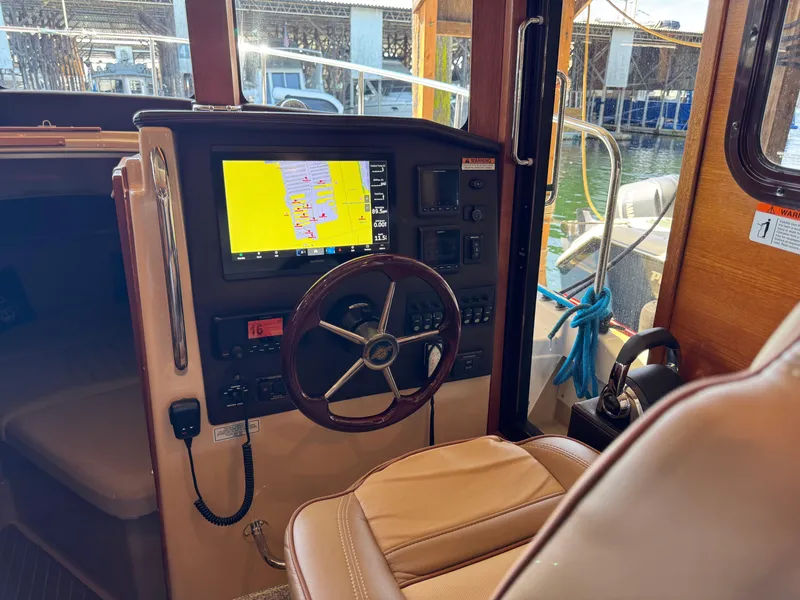 Slide: The Image of Interior of 2020 Ranger Tugs R-31 S boat with navigation system and steering wheel. - 23