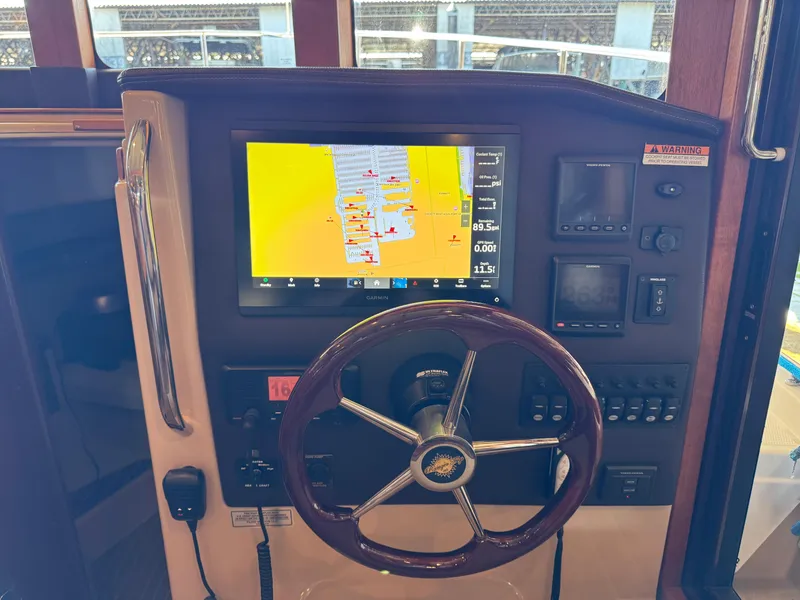 Slide: The Image of 2020 Ranger Tugs R-31 S helm with navigation display and steering wheel. - 24