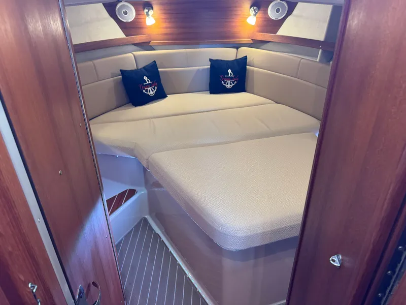 Slide: The Image of 2020 Ranger Tugs R-31 S cabin interior with cozy bed and nautical decor. - 25