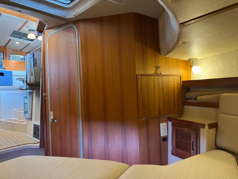 Slide: The Image of Interior of 2020 Ranger Tugs R-31 S with wood paneling and cozy seating area. - 28