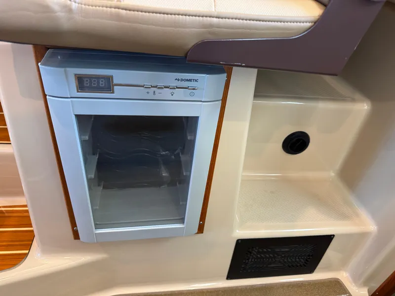 Slide: The Image of 2020 Ranger Tugs R-31 S interior with Dometic fridge and seating area. - 31