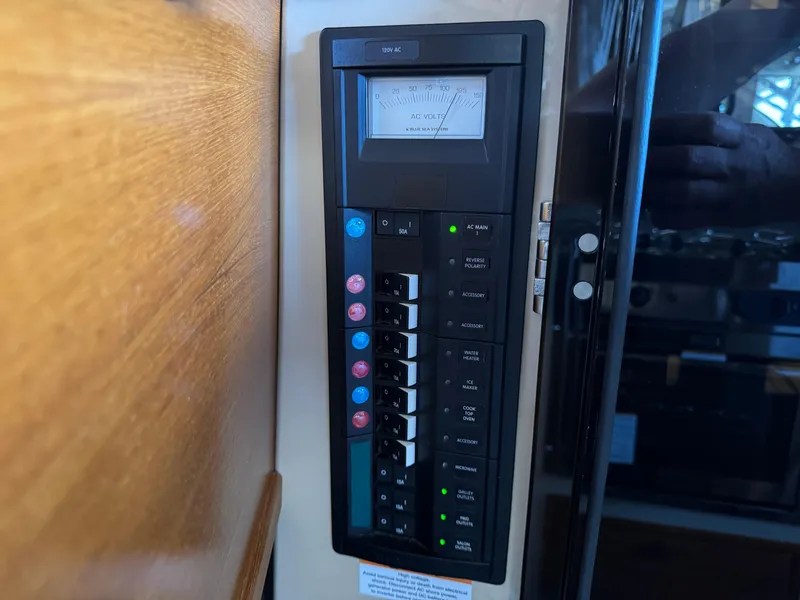 Slide: The Image of Electrical panel inside 2020 Ranger Tugs R-31 S boat, featuring circuit breakers and voltage meter. - 37