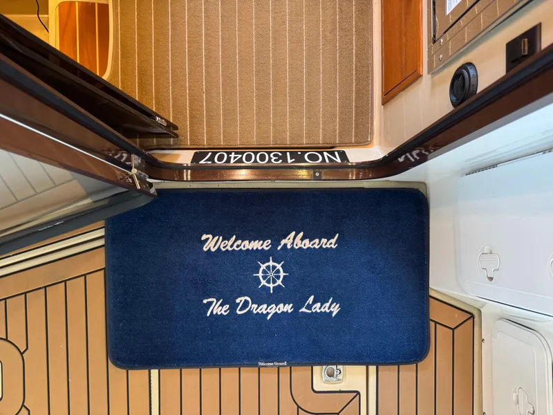 Slide: The Image of Welcome mat on 2020 Ranger Tugs R-31 S boat, reading "Welcome Aboard The Dragon Lady." - 9