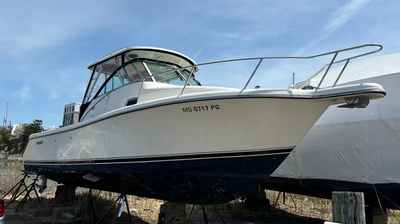 Slide: The Image of 2007 Pursuit 285 Offshore boat on dry dock, side view under clear sky. - 1