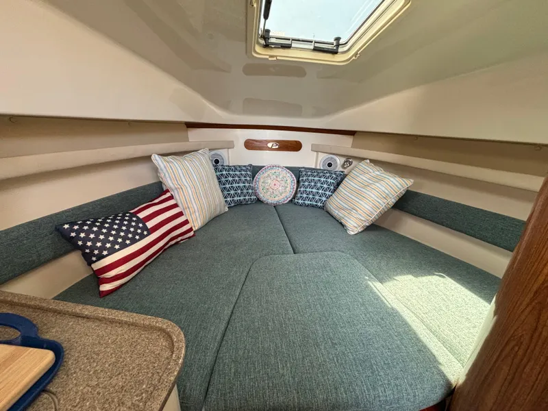 Slide: The Image of Cozy cabin interior of 2007 Pursuit 285 Offshore with cushions and natural light. - 18