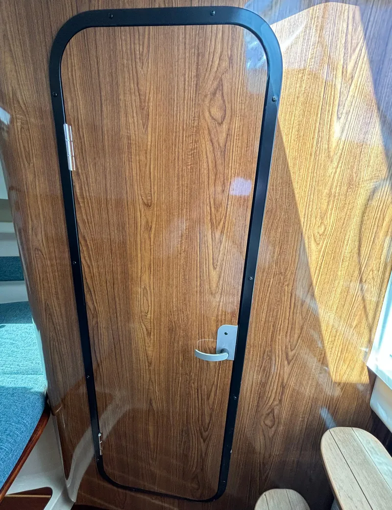 Slide: The Image of Wooden cabin door inside 2007 Pursuit 285 Offshore boat. - 23