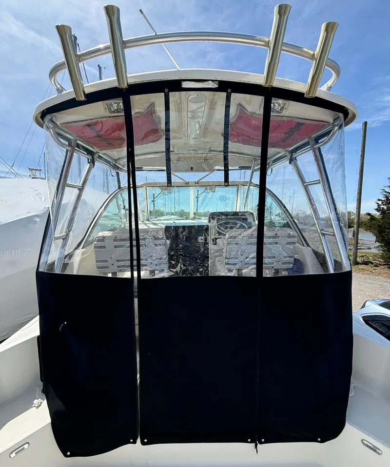 Slide: The Image of 2007 Pursuit 285 Offshore boat with enclosed cockpit and rod holders. - 9