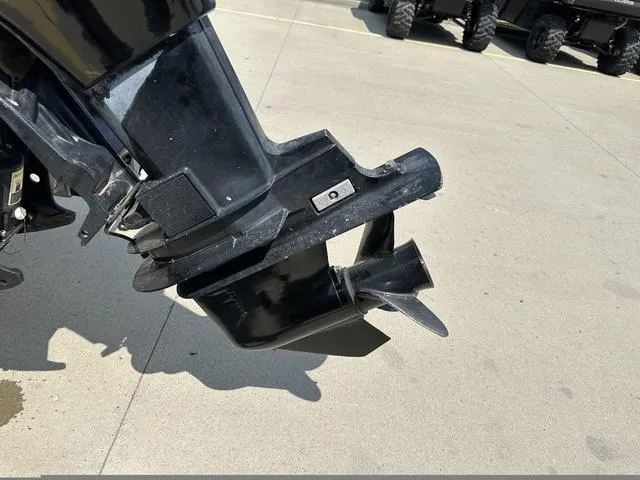 Slide: The Image of Outboard motor of a 2002 Bayliner 160 Capri on a concrete surface. - 21