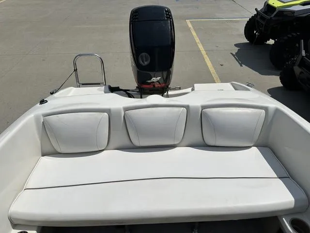 Slide: The Image of 2002 Bayliner 160 Capri boat interior with white seating and outboard motor. - 25
