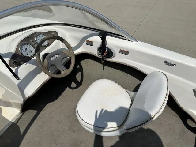 Slide: The Image of 2002 Bayliner 160 Capri boat interior with steering wheel and seat. - 26