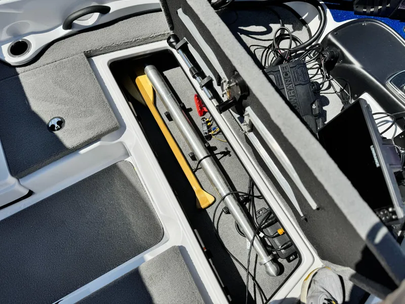 Slide: The Image of 2021 Nitro Z19 Sport boat storage compartment with fishing gear and equipment. - 12