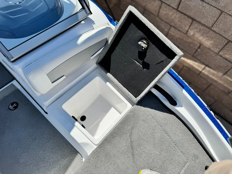 Slide: The Image of 2021 Nitro Z19 Sport boat storage compartment with open lid, showcasing interior space. - 16