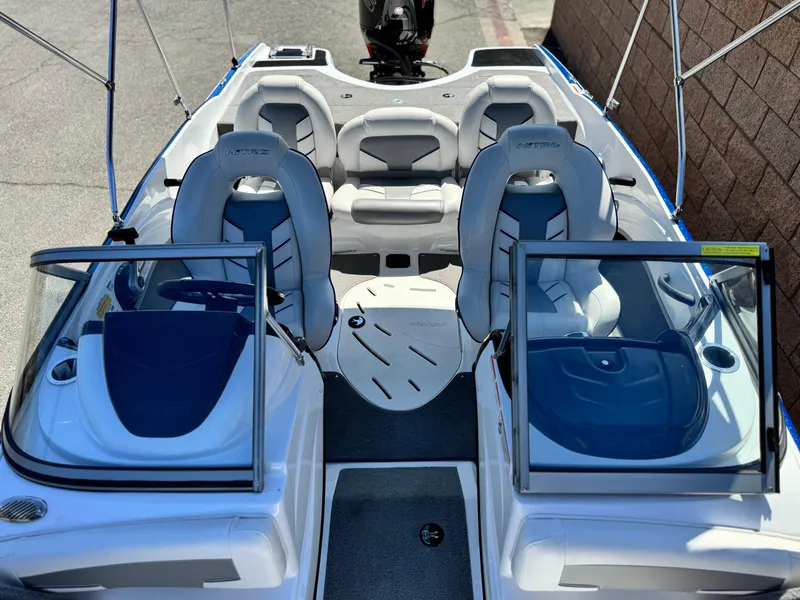 Slide: The Image of 2021 Nitro Z19 Sport boat interior with seating and open windshield. - 18