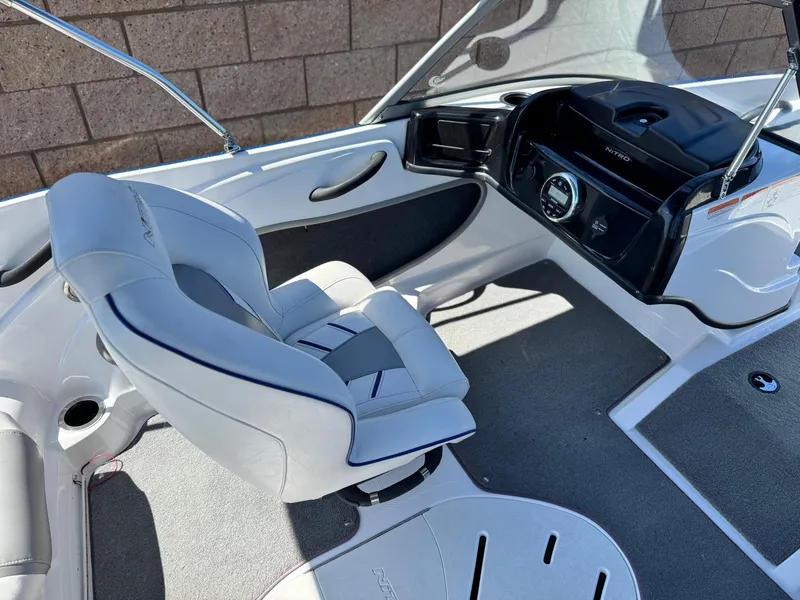 Slide: The Image of Interior of a 2021 Nitro Z19 Sport boat featuring a sleek captain's chair and modern dashboard. - 22