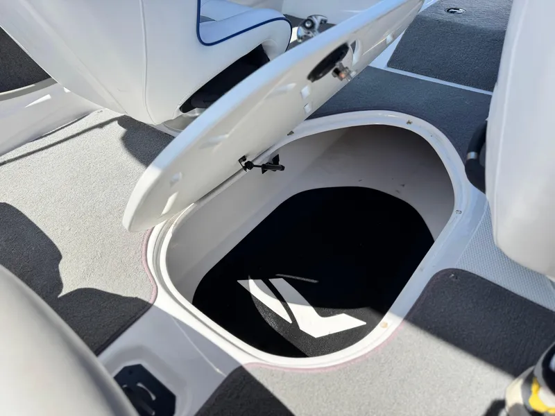Slide: The Image of 2021 Nitro Z19 Sport boat storage compartment open, revealing spacious interior. - 24