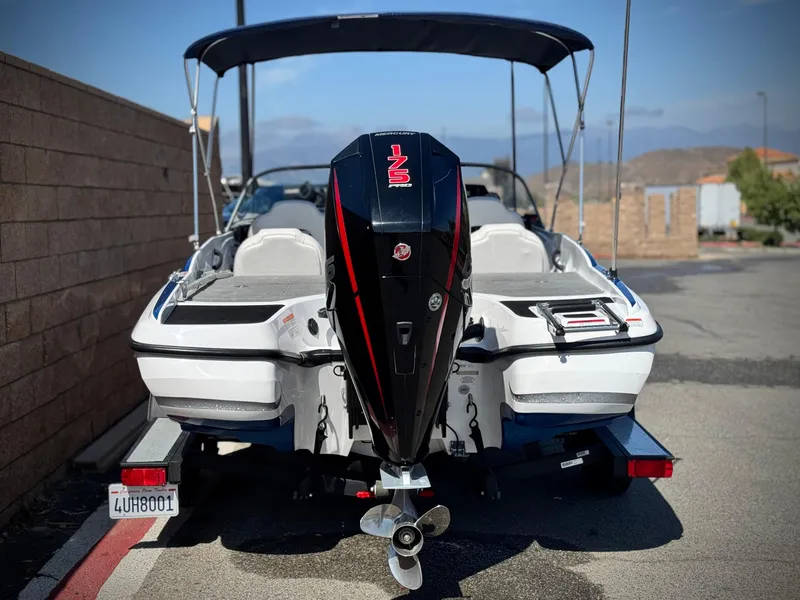 Slide: The Image of 2021 Nitro Z19 Sport boat with outboard motor, parked on a trailer. - 5