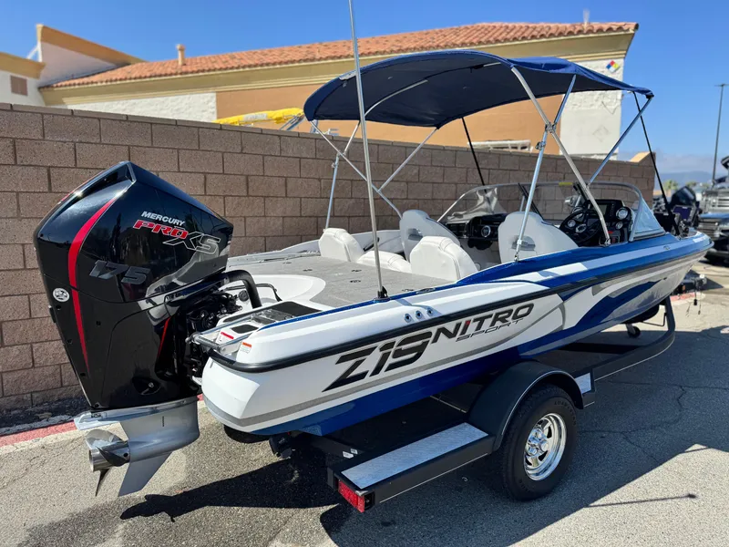 Slide: The Image of 2021 Nitro Z19 Sport boat with Mercury engine, parked on a trailer. - 6