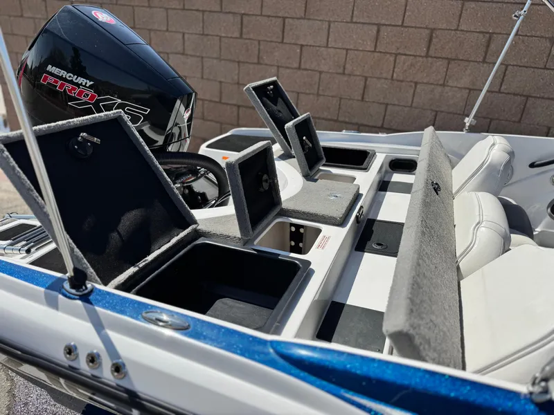 Slide: The Image of 2021 Nitro Z19 Sport boat with open storage compartments and Mercury Pro XS engine. - 9