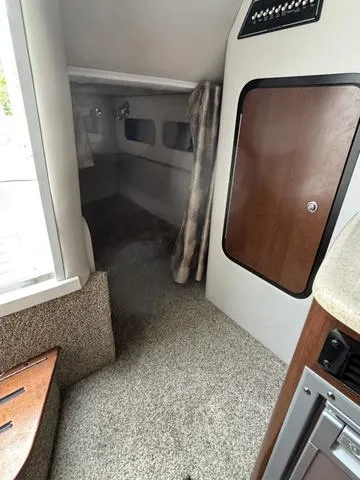 Slide: The Image of 2022 Crownline 264 CR cabin interior with cozy sleeping area and modern amenities. - 10