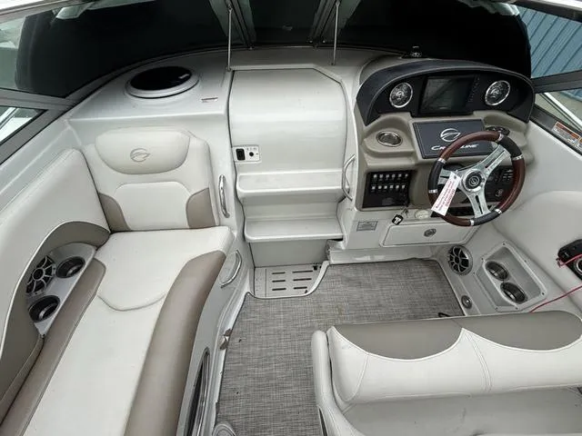Slide: The Image of 2022 Crownline 264 CR boat interior with modern dashboard and seating. - 11