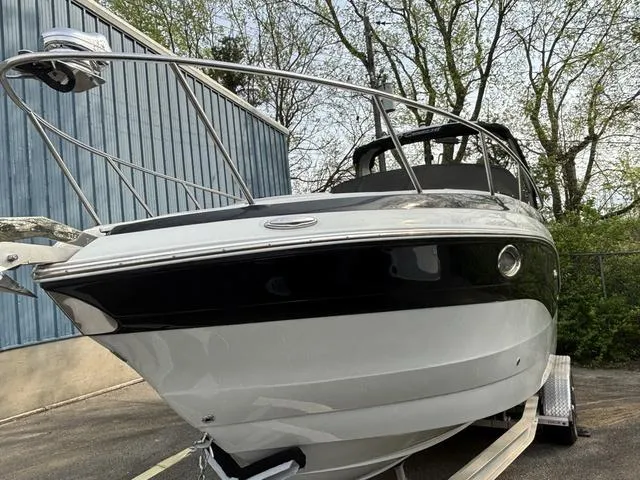 Slide: The Image of 2022 Crownline 264 CR boat on trailer, sleek design, black and white exterior. - 3