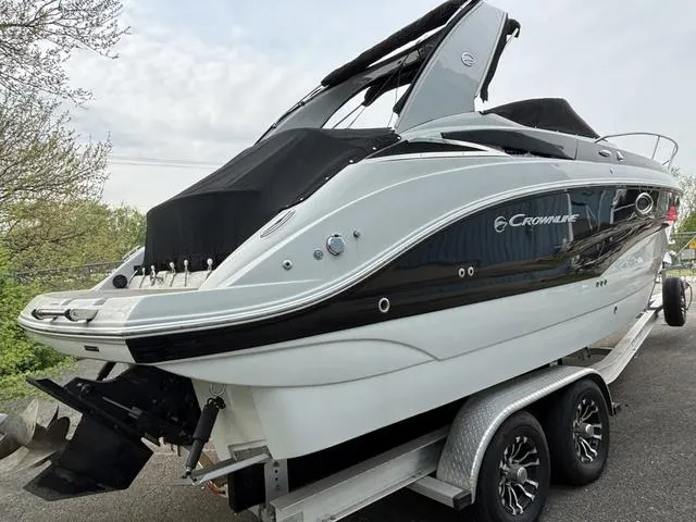 Slide: The Image of 2022 Crownline 264 CR boat on trailer, sleek design, black and white color scheme. - 5