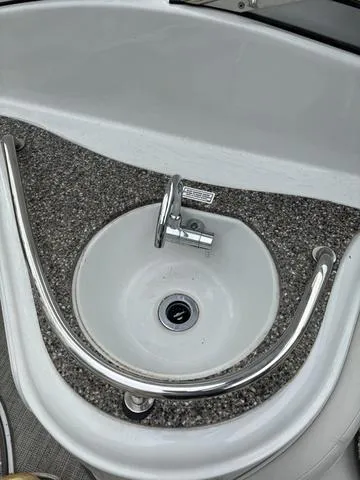 Slide: The Image of 2022 Crownline 264 CR boat sink with chrome faucet and railing. - 6