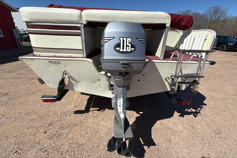Slide: The Image of Rear view of a 2000 Lowe 192/DB boat with a 115 horsepower outboard motor. - 2