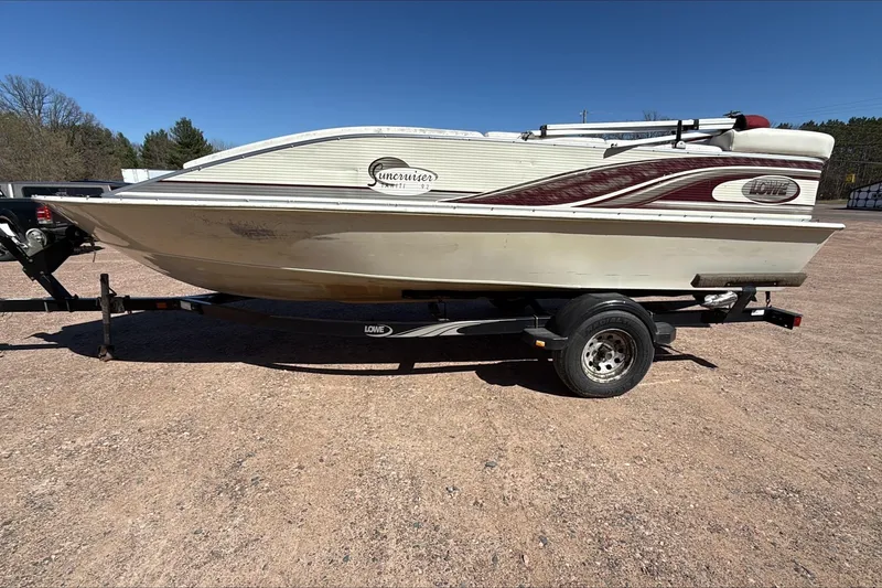 Slide: The Image of Lowe 192/DB boat on trailer, side view, outdoors, sunny day, 2000 model. - 3
