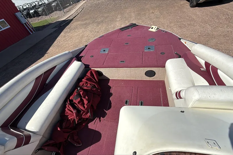 Slide: The Image of Interior of a 2000 Lowe 192/DB boat with red and white seating. - 4
