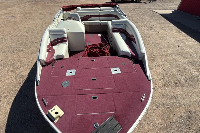 Slide: The Image of Lowe 192/DB boat, 2000 model, with red and white interior, parked on gravel. - 5