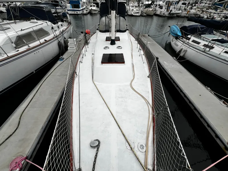 Slide: The Image of 1974 Irwin 37 Center Cockpit sailboat docked in a marina, surrounded by other boats. - 12
