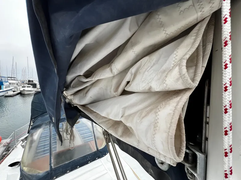 Slide: The Image of Rolled sail on 1974 Irwin 37 Center Cockpit yacht, docked in marina. - 14