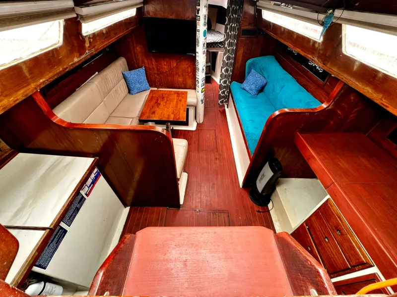 Slide: The Image of Interior of 1974 Irwin 37 Center Cockpit sailboat with cozy seating and wooden finishes. - 19