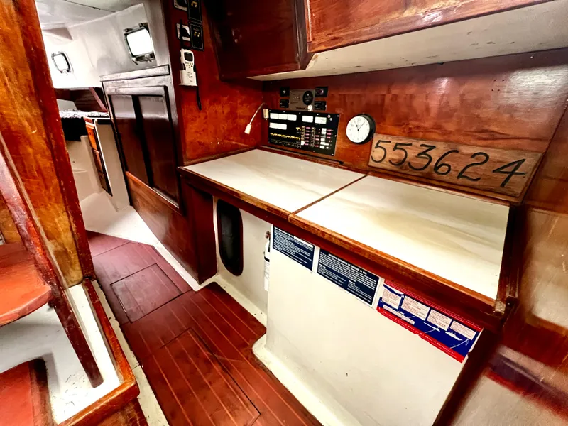 Slide: The Image of 1974 Irwin 37 Center Cockpit interior with wooden cabinetry and navigation equipment. - 22