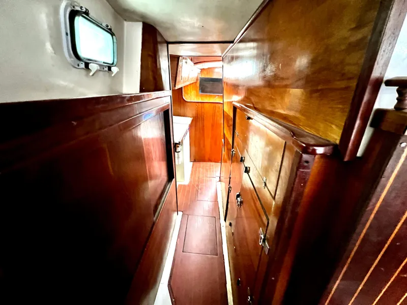 Slide: The Image of Interior of 1974 Irwin 37 Center Cockpit with wooden cabinetry and porthole window. - 23