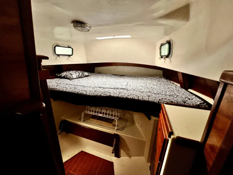 Slide: The Image of 1974 Irwin 37 Center Cockpit cabin interior with bed and wooden cabinetry. - 25
