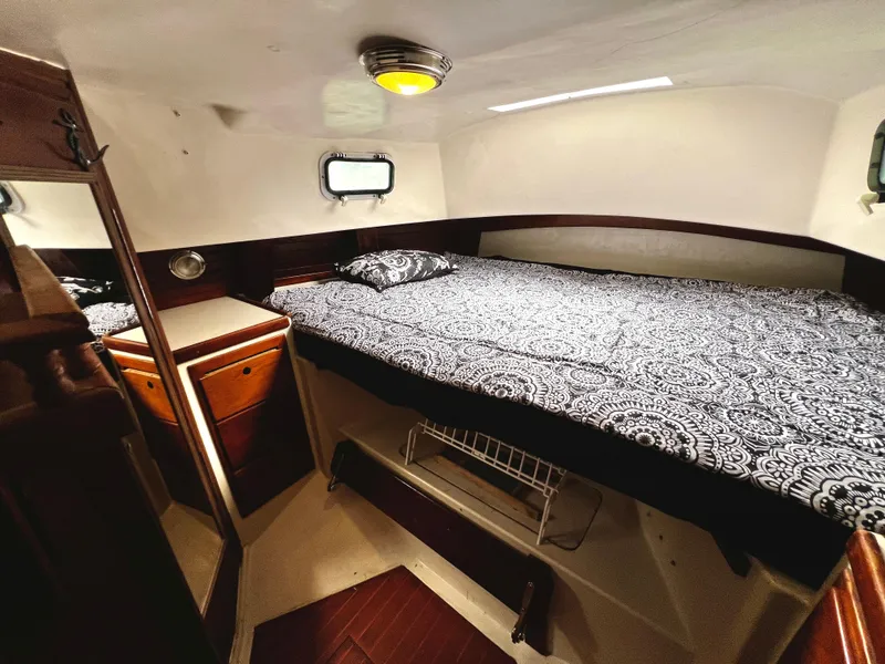 Slide: The Image of Cozy cabin interior of 1974 Irwin 37 Center Cockpit with patterned bedding and wooden cabinetry. - 26