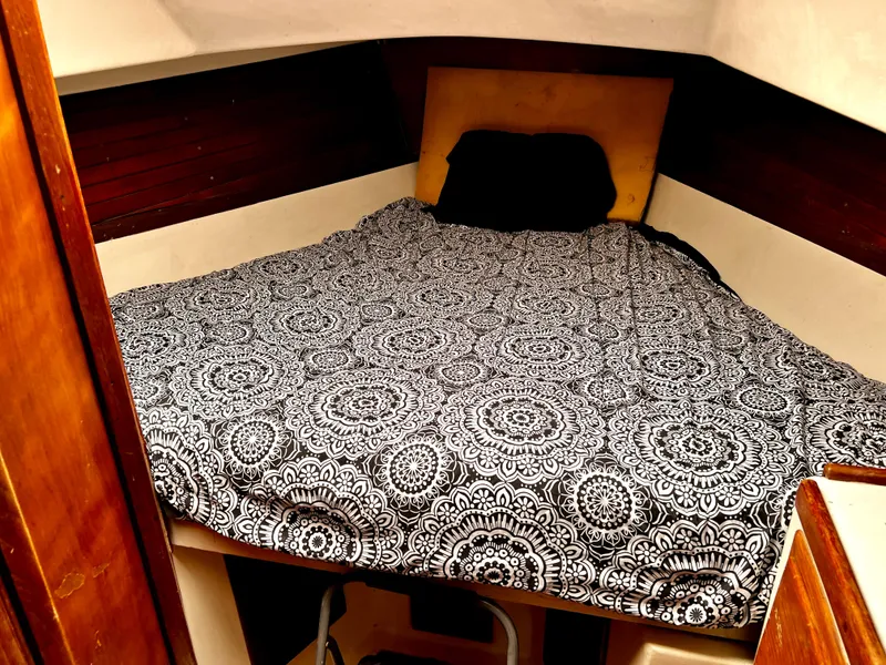 Slide: The Image of 1974 Irwin 37 Center Cockpit cabin with patterned bedding and wooden interior. - 29